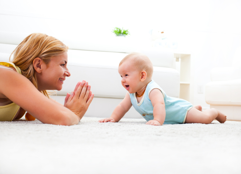 Woman and baby on carpet