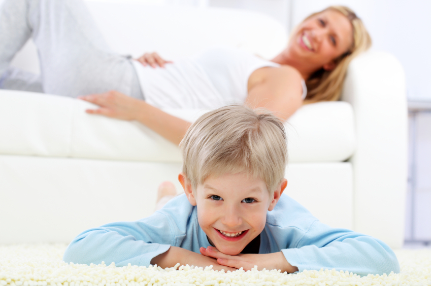 Boy laying on a carpet